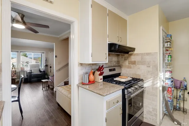a kitchen with a stove and a refrigerator