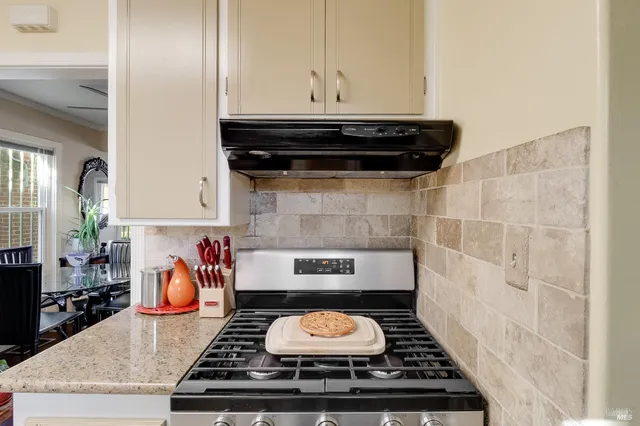 a stove top oven sitting inside of a kitchen