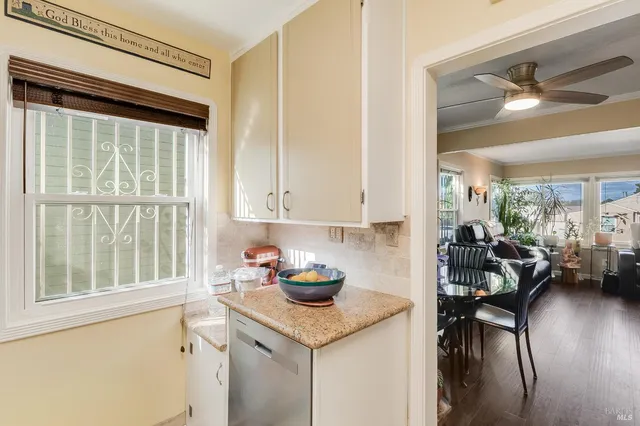 a kitchen with a sink cabinets and wooden floor