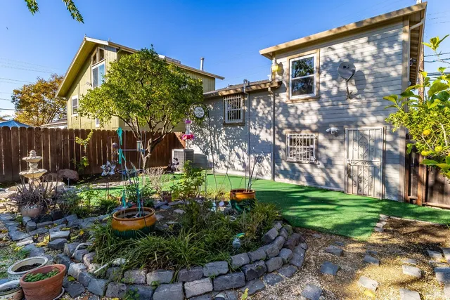 a view of a backyard with plants and a patio