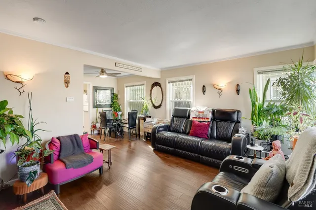 a living room with furniture and wooden floor
