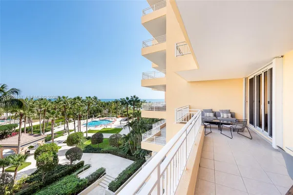 a balcony with outdoor seating and plants