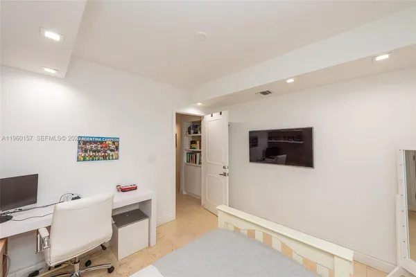 a view of a livingroom with workspace and a window