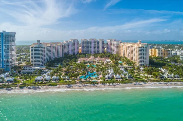 an aerial view of residential houses with outdoor space and street view