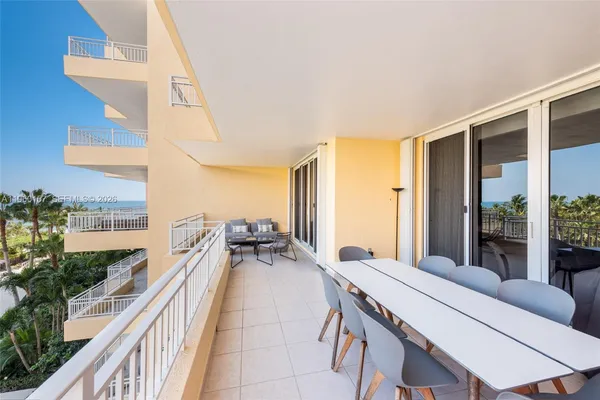 a living room with furniture and large windows