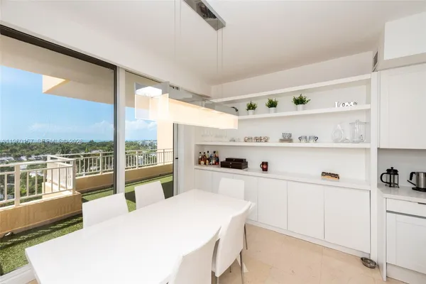 a large white kitchen with a large window