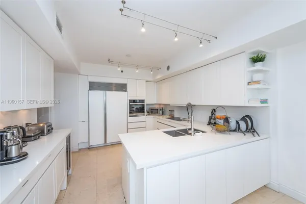 a kitchen a sink a stove and cabinets