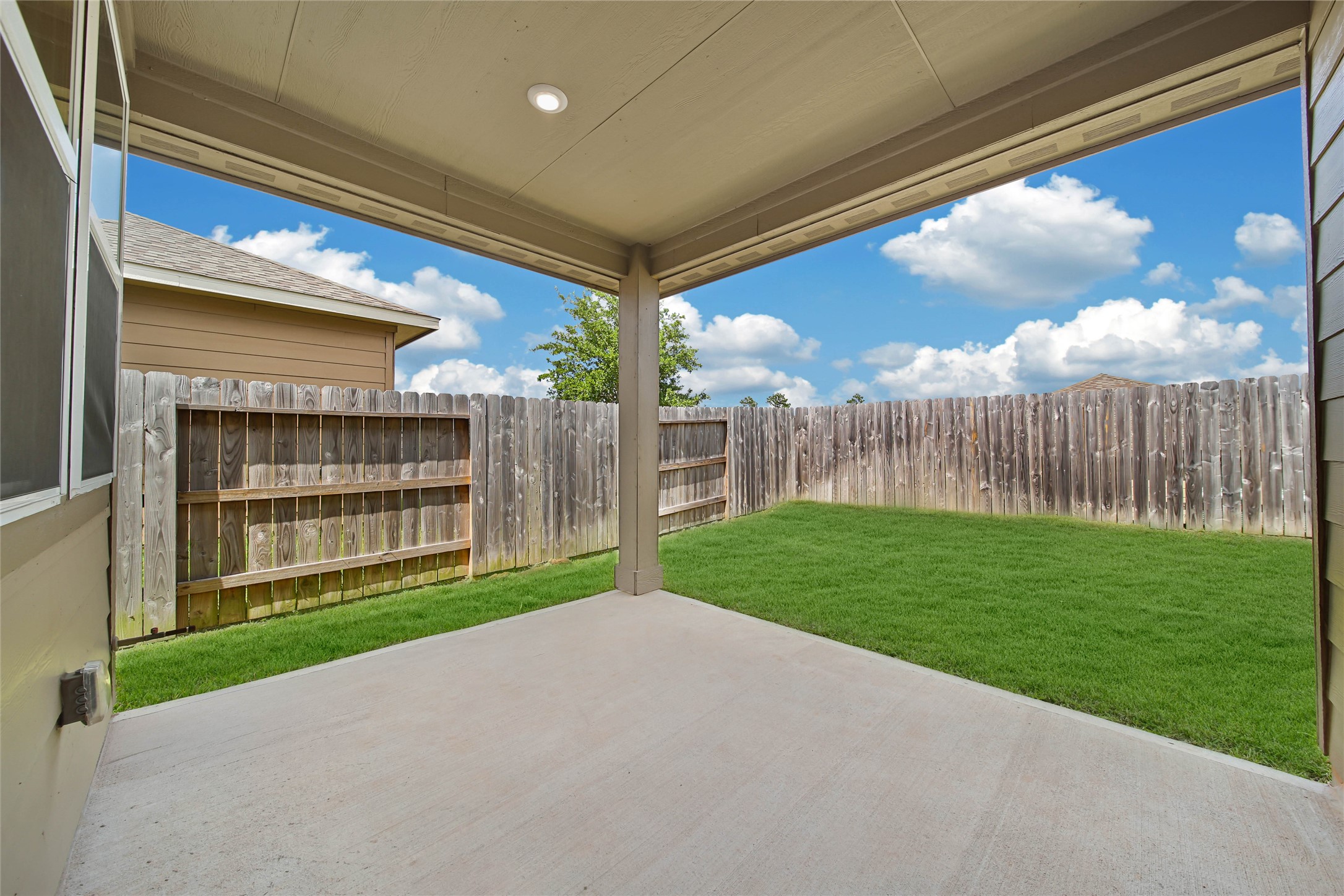 7080 Silverleaf Oak Street Conroe, TX 77304 - Photo 20 of 35 The patio is a perfect size for relaxing to enjoy your new backyard. There is a natural gas line available for your grill. This grass has been greened by AI.