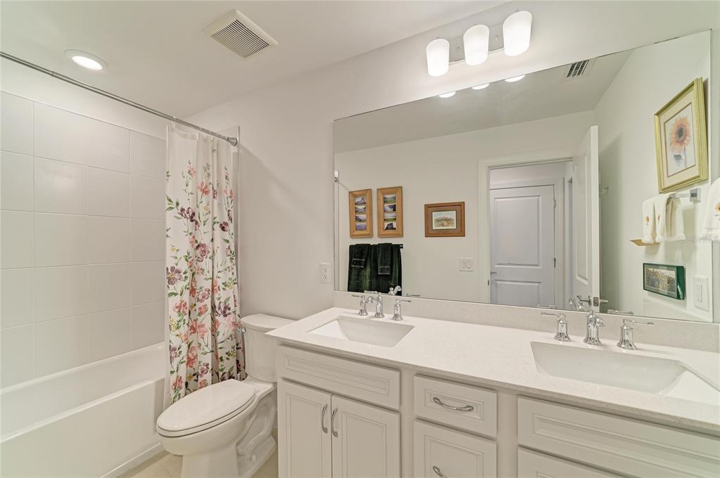 16341 Hidden Oak Loop Lakewood Ranch, FL 34211 - Photo 51 of 76 a bathroom with a sink a toilet and shower