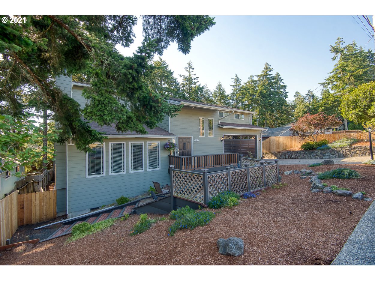 1845 Oak Street North Bend, OR 97459 - Photo 1 of 31 a backyard of a house with garden and barbeque oven