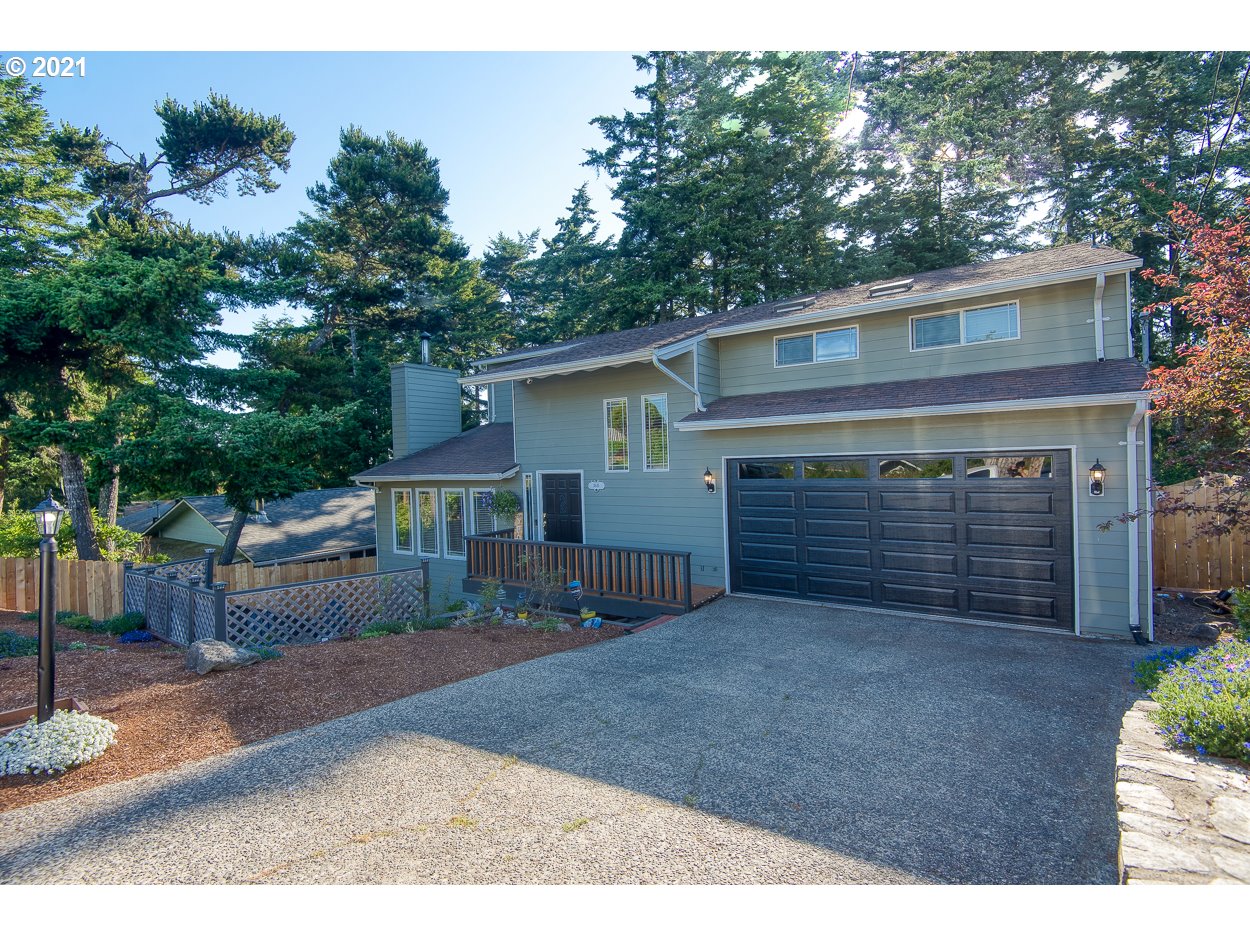 1845 Oak Street North Bend, OR 97459 - Photo 2 of 31 a front view of house with yard and trees in the background