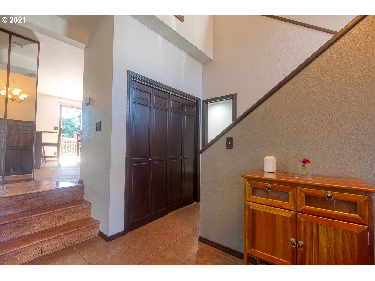 1845 Oak Street North Bend, OR 97459 - Photo 11 of 31 a kitchen with stainless steel appliances kitchen island granite countertop a refrigerator and a sink
