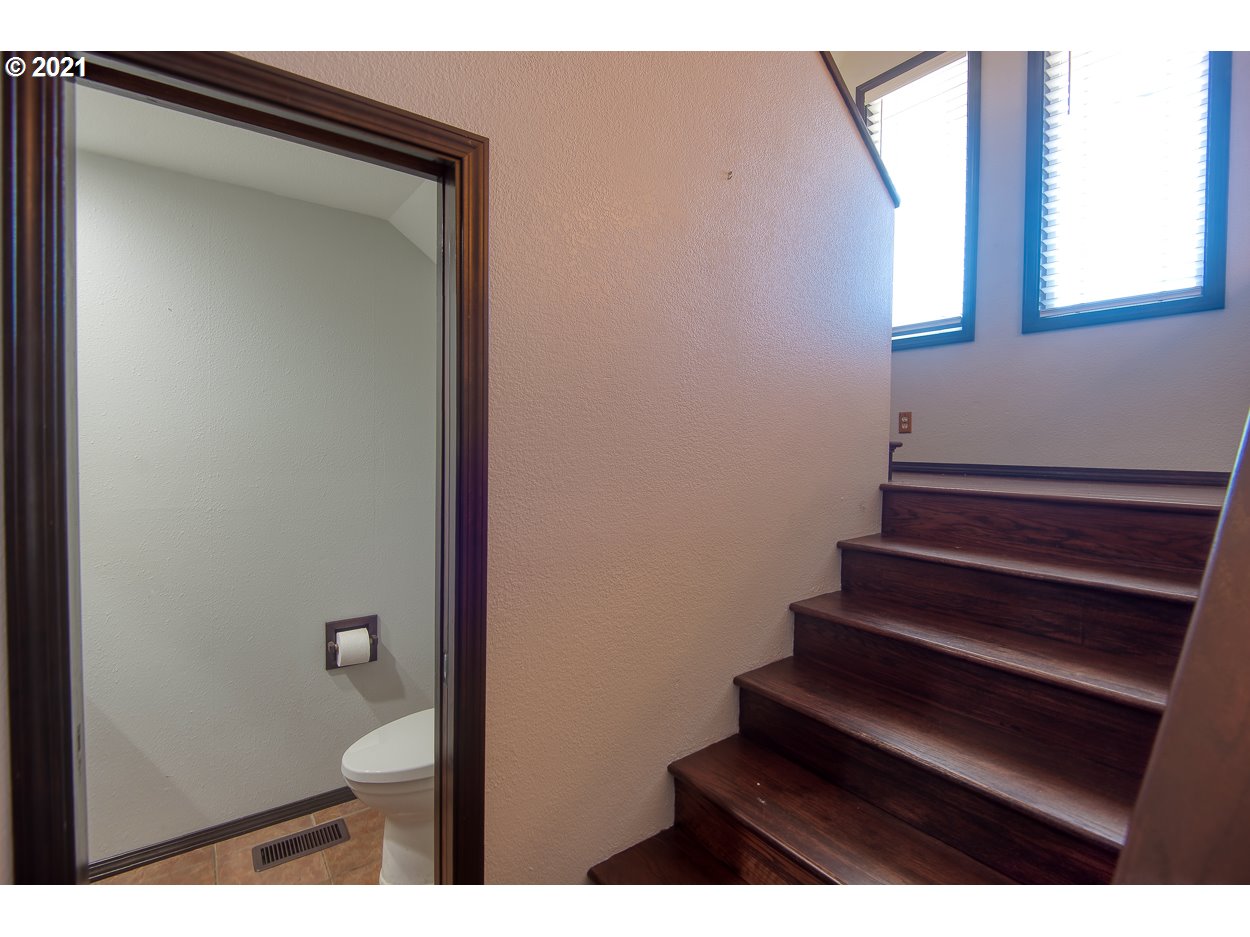 1845 Oak Street North Bend, OR 97459 - Photo 13 of 31 a bathroom with a granite countertop sink and a mirror