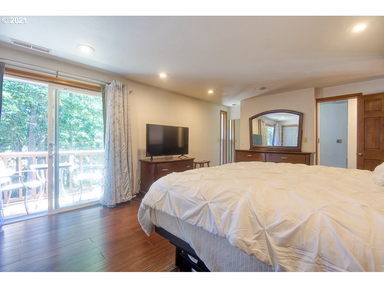 1845 Oak Street North Bend, OR 97459 - Photo 16 of 31 a spacious bedroom with a bed and a dresser