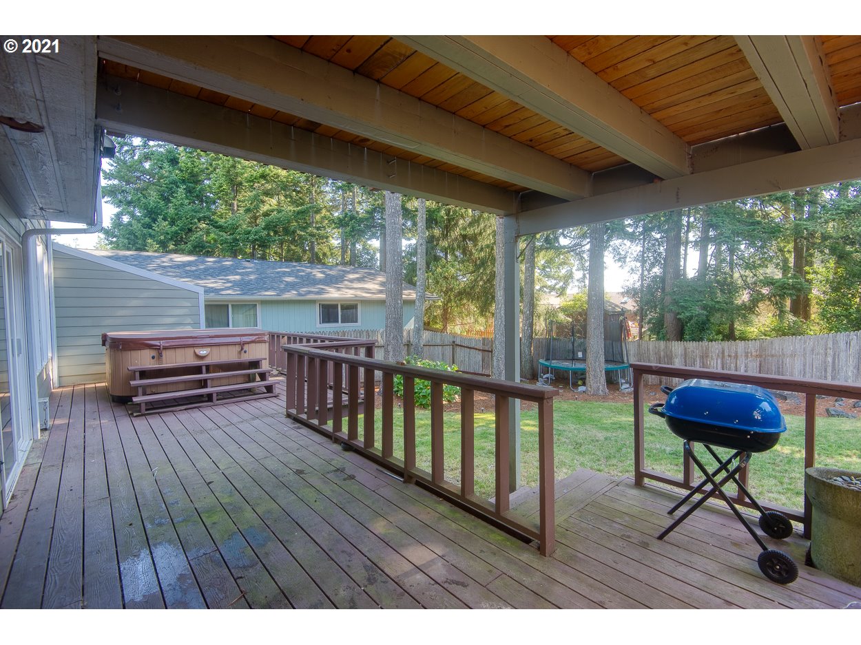 1845 Oak Street North Bend, OR 97459 - Photo 26 of 31 a view of a patio with table and chairs with wooden floor and fence
