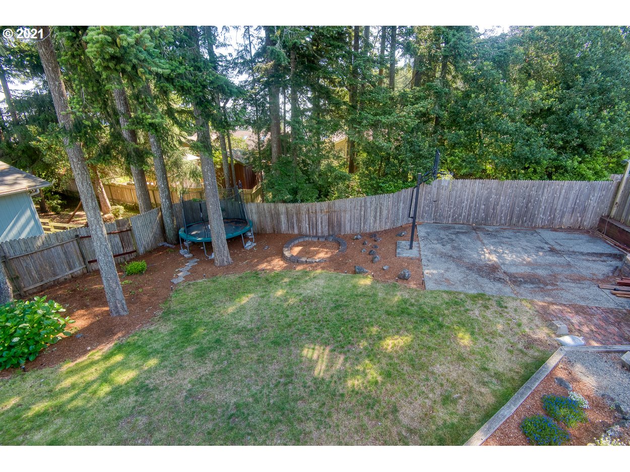1845 Oak Street North Bend, OR 97459 - Photo 29 of 31 a view of a backyard with a small cabin and a chair