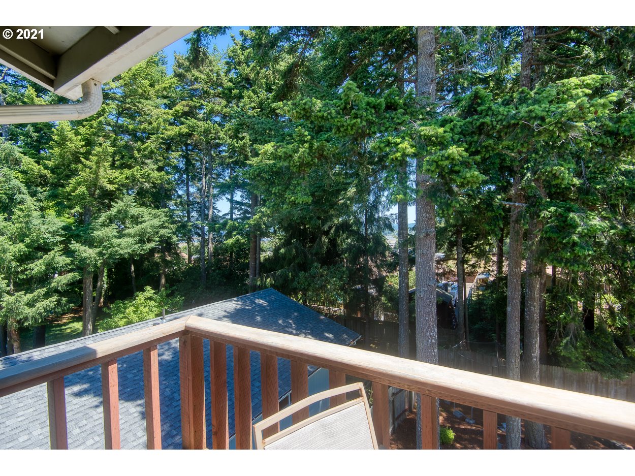1845 Oak Street North Bend, OR 97459 - Photo 31 of 31 a backyard of a house with table and chairs a barbeque with wooden fence