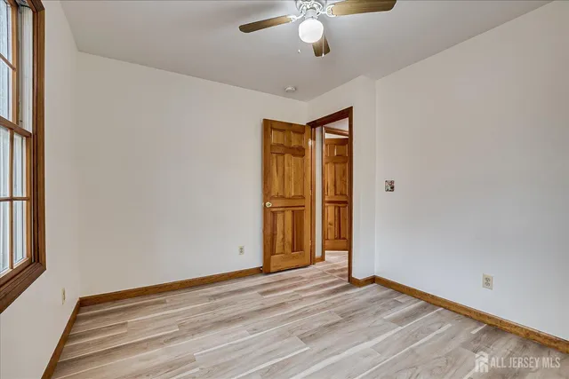 a view of hallway with wooden floor and furniture
