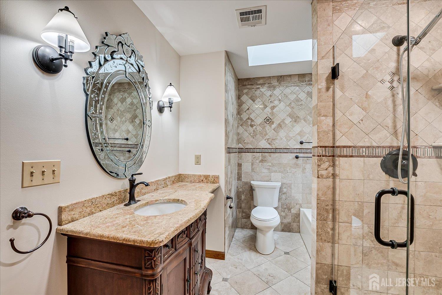 23 Cardownie Street Edison, NJ 08817 - Photo 23 of 65 a bathroom with a granite countertop sink a toilet and a mirror