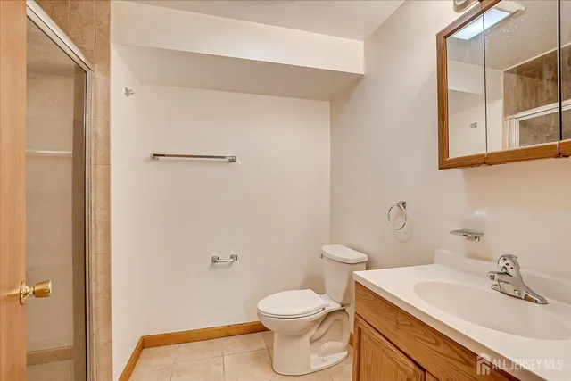 a kitchen with stainless steel appliances granite countertop a stove top oven a sink dishwasher and white cabinets with wooden floor