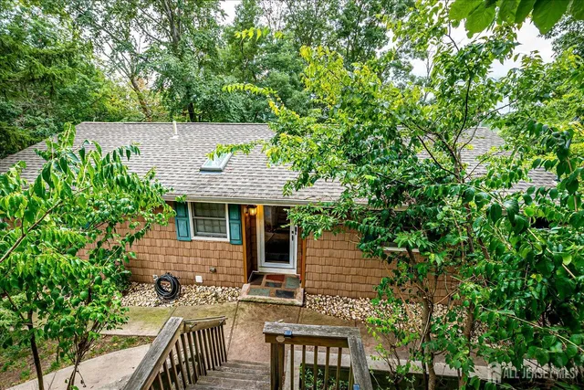 a en suite bathroom with a granite countertop sink and a mirror