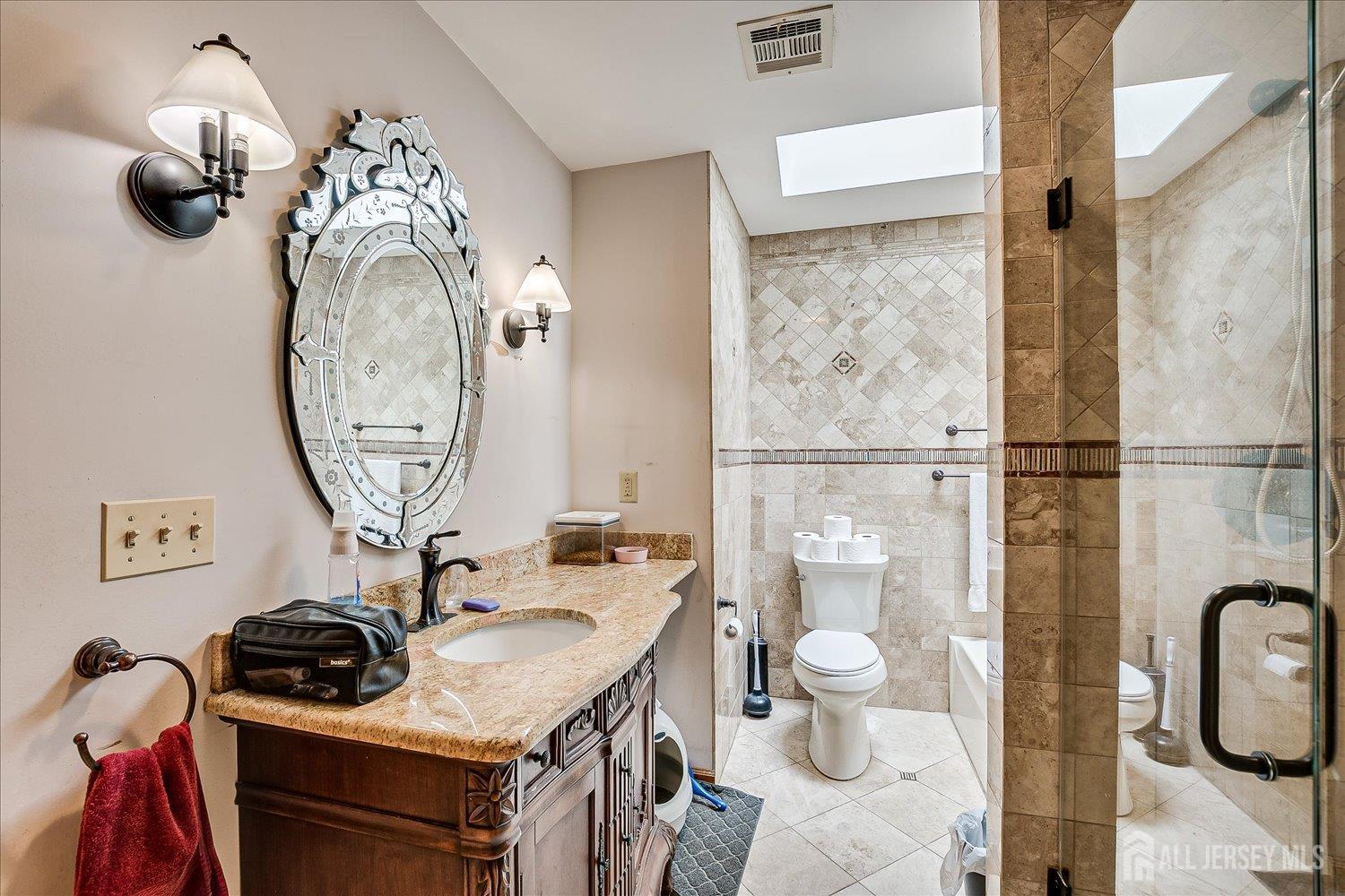 23 Cardownie Street Edison, NJ 08817 - Photo 50 of 65 a bathroom with a sink a toilet and a mirror