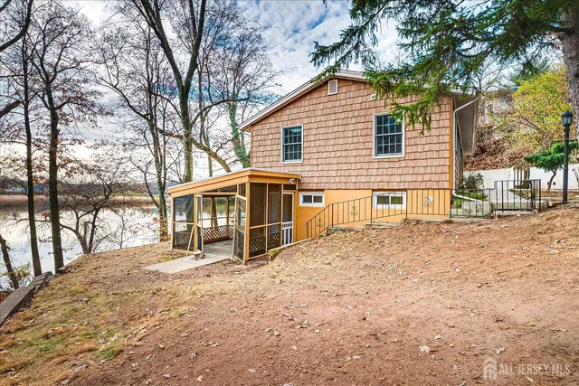 a view of an empty room with a fireplace and a large window