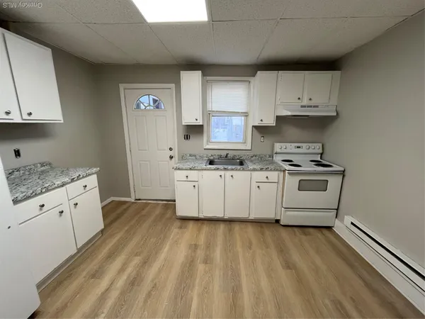 a kitchen with cabinets a sink and a stove