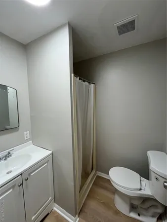 a bathroom with a toilet sink and vanity