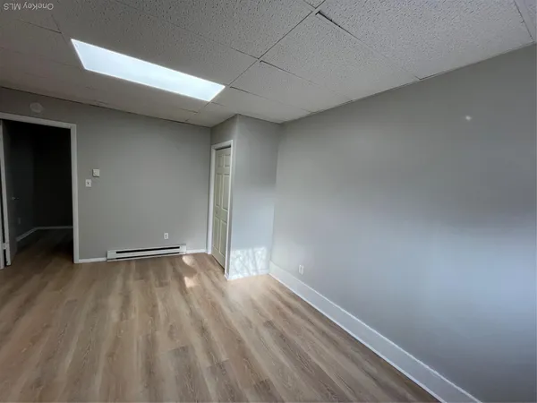 a view of an empty room and wooden floor