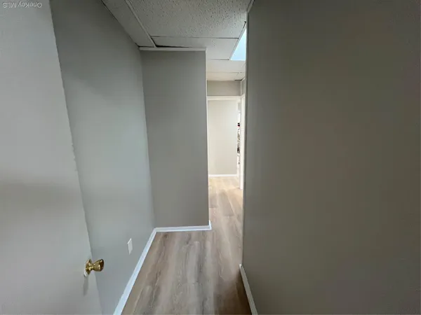 a view of a room with wooden floor and a window