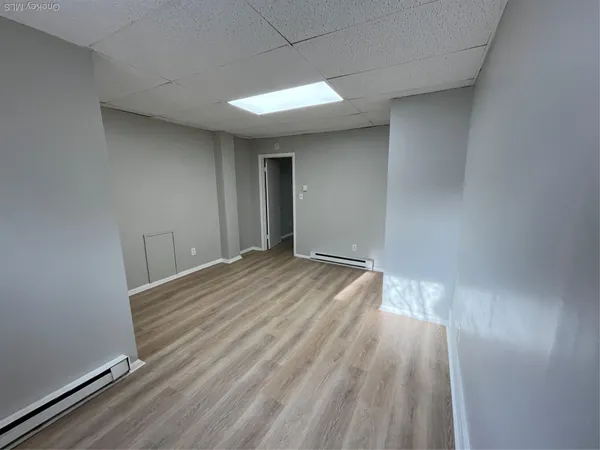 an empty room with wooden floor