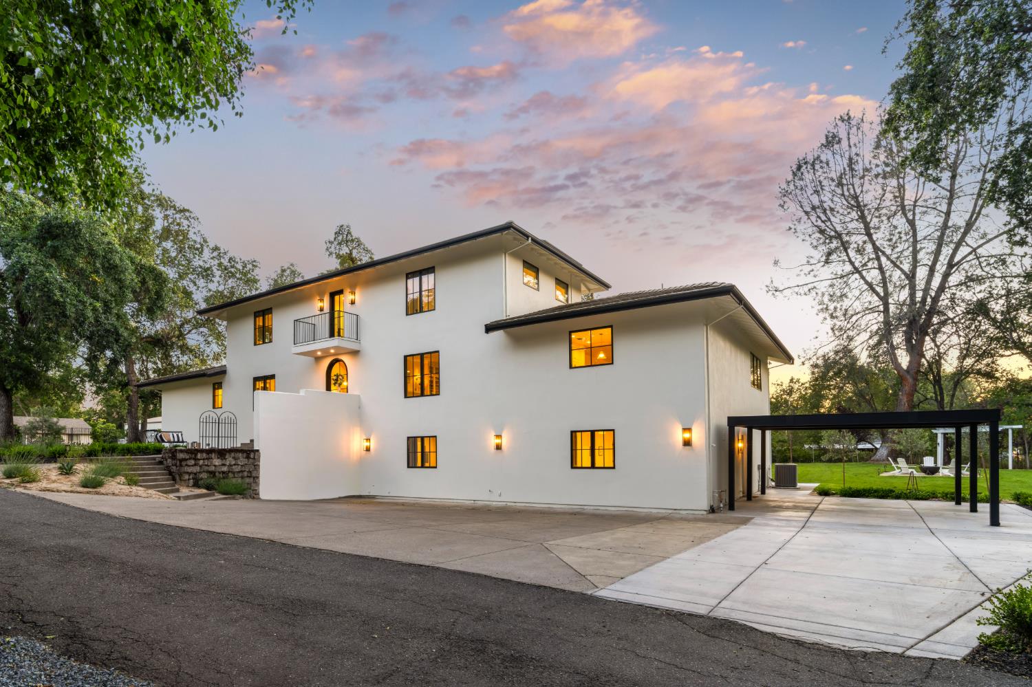 7697 Horseshoe Bar Road Loomis, CA 95650 - Photo 3 of 76 a view of a white house with a yard and large trees