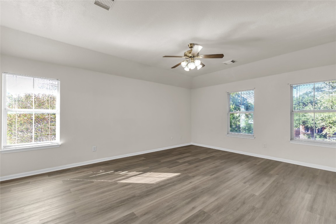 3733 Eagles Nest Street Round Rock, TX 78665 - Photo 11 of 19 a view of empty room with wooden floor and fan