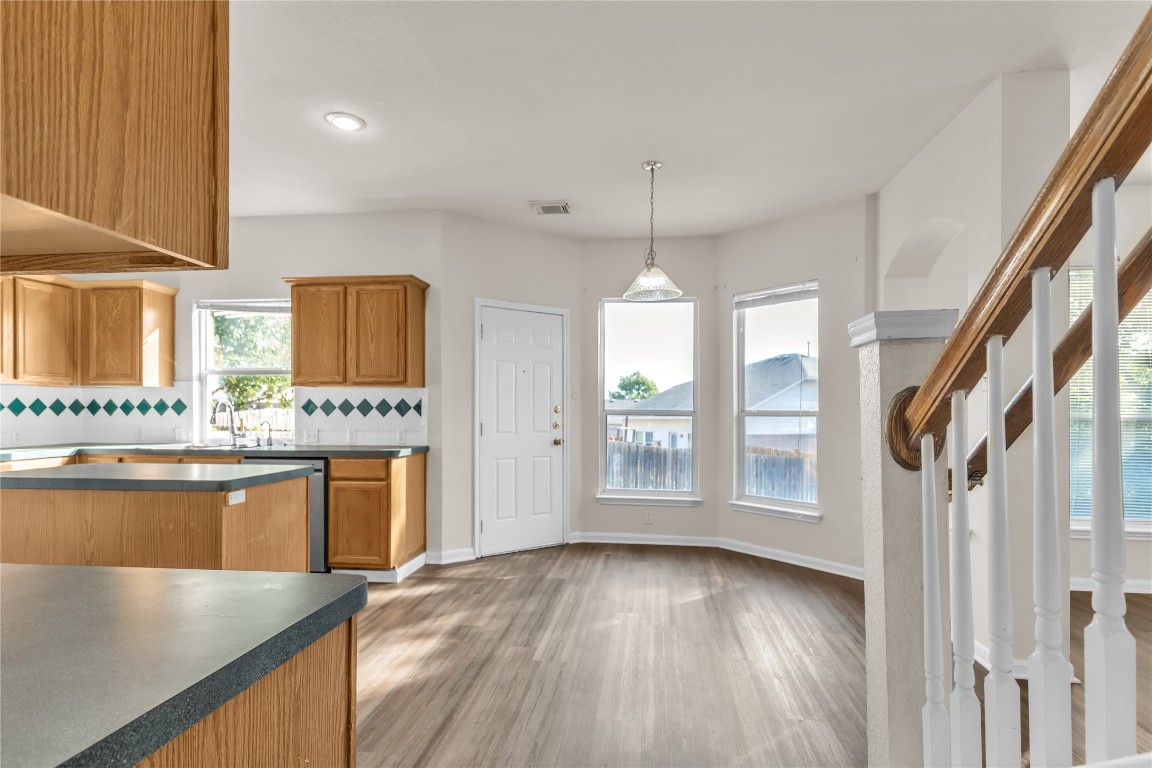 3733 Eagles Nest Street Round Rock, TX 78665 - Photo 4 of 19 a view of a kitchen with a sink wooden floor and a living room