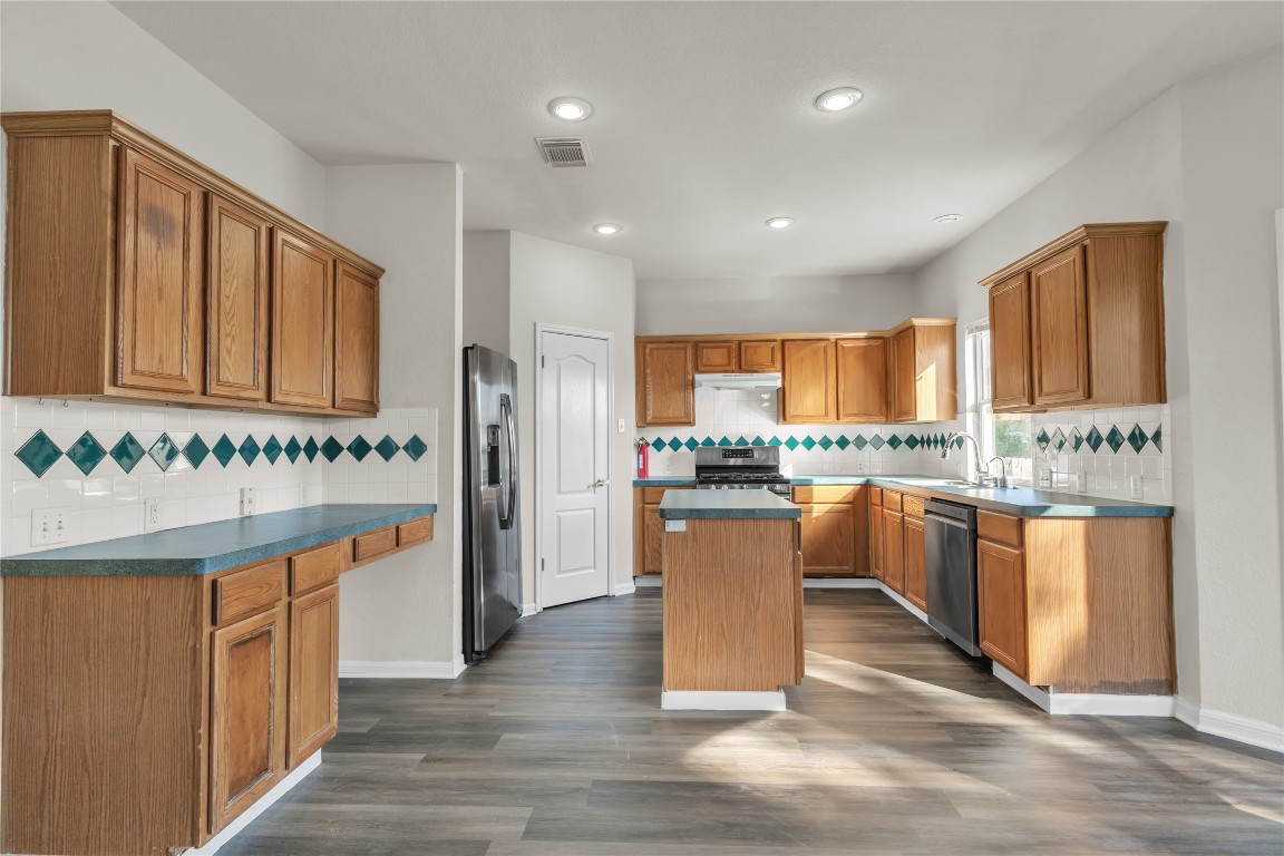 3733 Eagles Nest Street Round Rock, TX 78665 - Photo 5 of 19 a kitchen with granite countertop lots of counter top space and stainless steel appliances