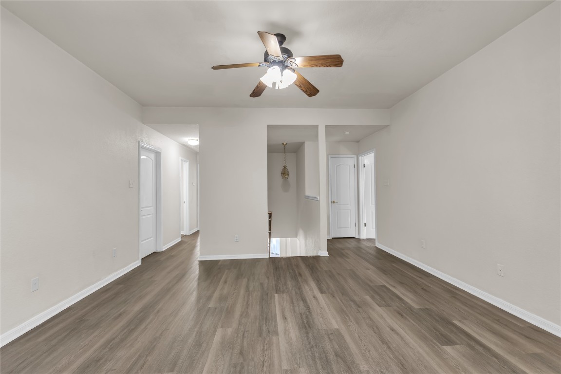 3733 Eagles Nest Street Round Rock, TX 78665 - Photo 10 of 19 a view of wooden floor and a chandelier fan in a room