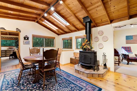 a living room with fireplace furniture and a large window