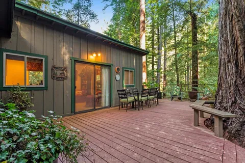 a backyard of a house with barbeque oven table and chairs