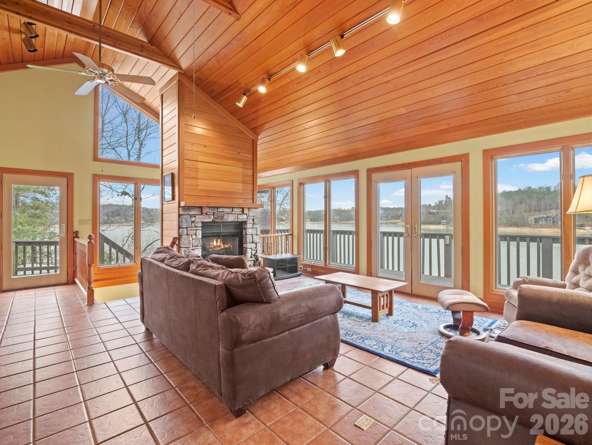 336 Burnt Ridge Road Lake Lure, NC 28746 - Photo 17 of 45 a living room with furniture and a floor to ceiling window
