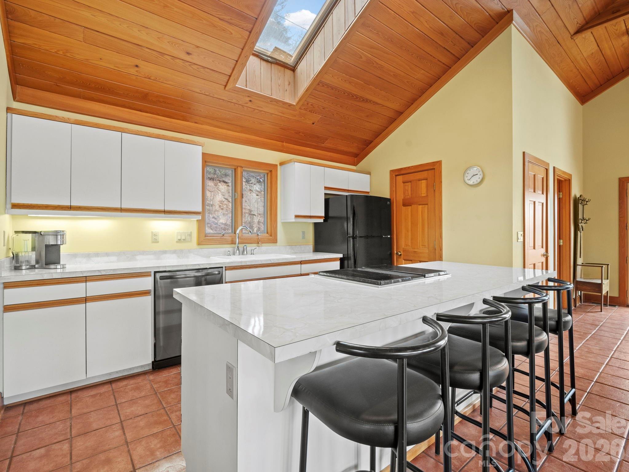 336 Burnt Ridge Road Lake Lure, NC 28746 - Photo 21 of 45 a kitchen with a table chairs sink and cabinets