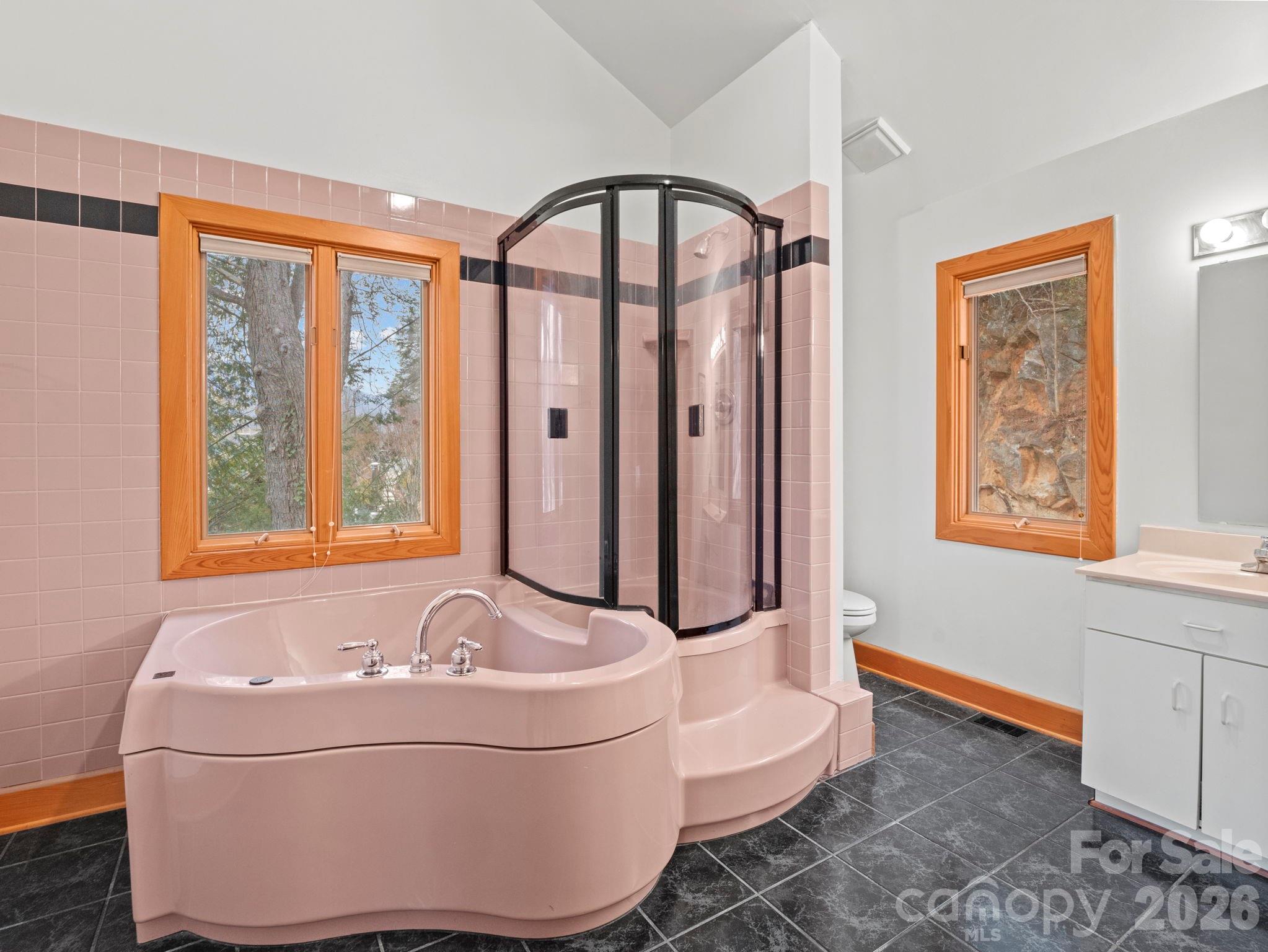 336 Burnt Ridge Road Lake Lure, NC 28746 - Photo 26 of 45 a bath tub sitting in a bathroom next to a window
