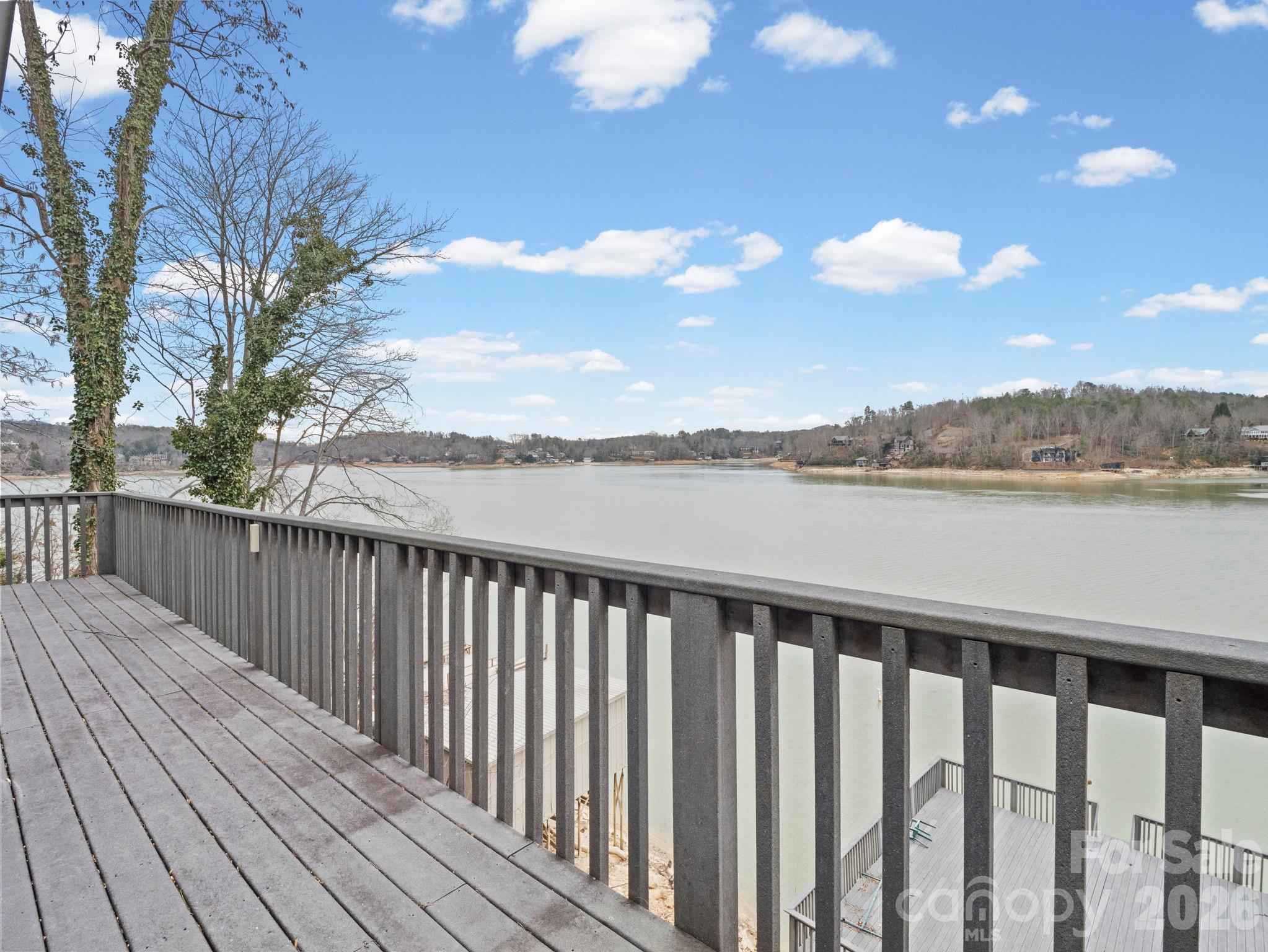 336 Burnt Ridge Road Lake Lure, NC 28746 - Photo 29 of 45 a balcony with wooden floor and lake view