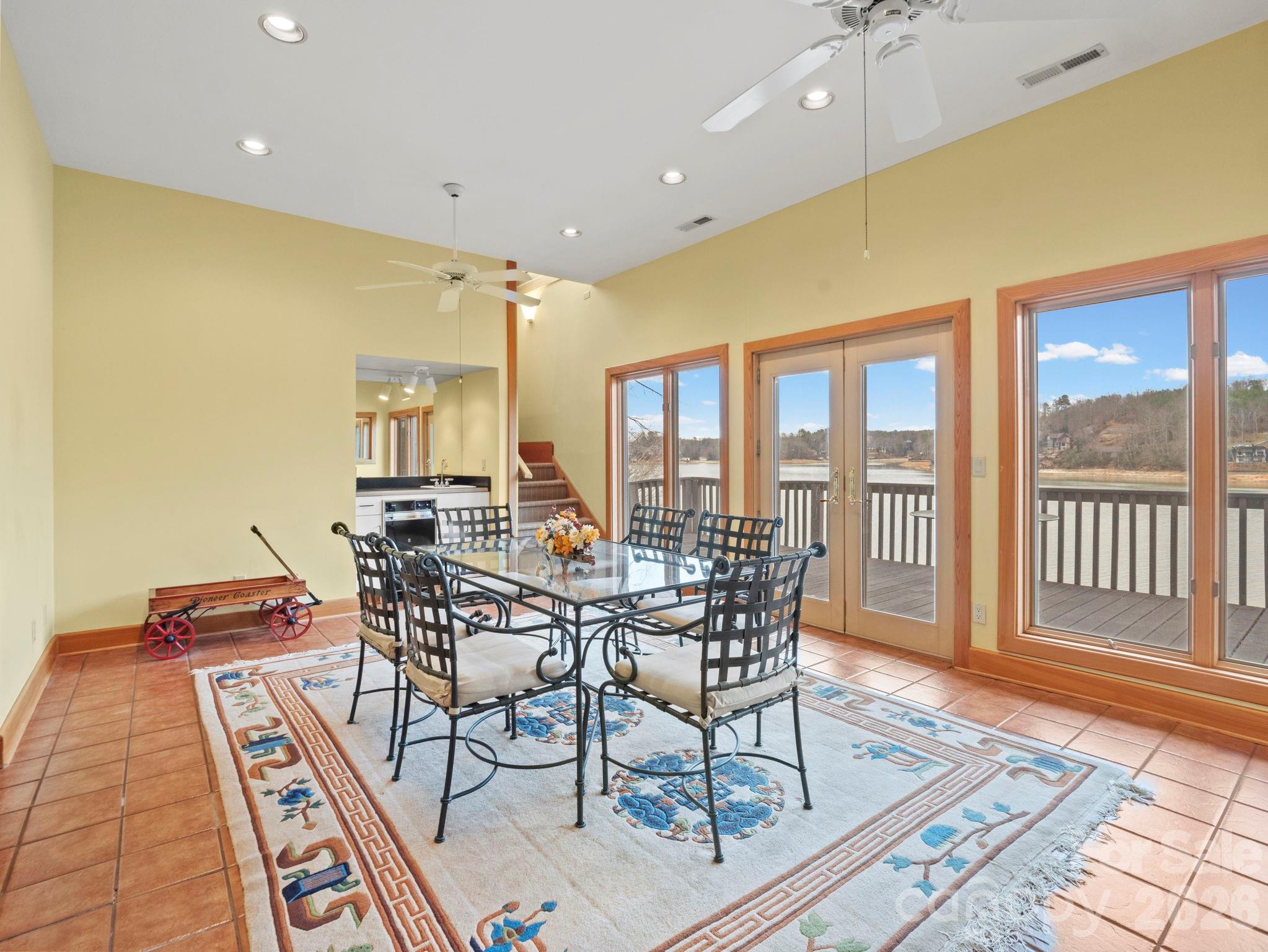 336 Burnt Ridge Road Lake Lure, NC 28746 - Photo 31 of 45 a view of a dining room with furniture a rug and wooden floor