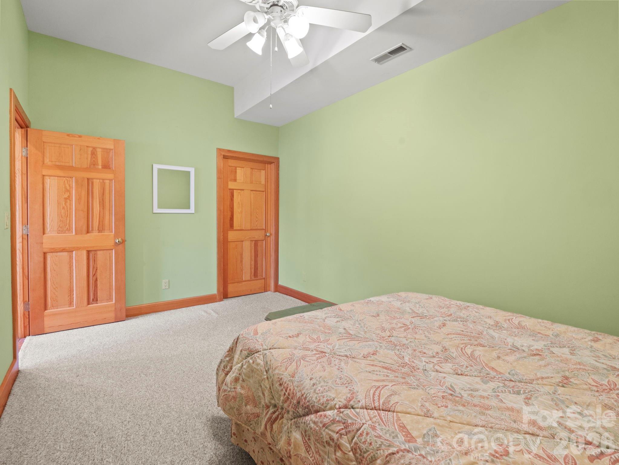 336 Burnt Ridge Road Lake Lure, NC 28746 - Photo 36 of 45 a bedroom with a bed and a chandelier