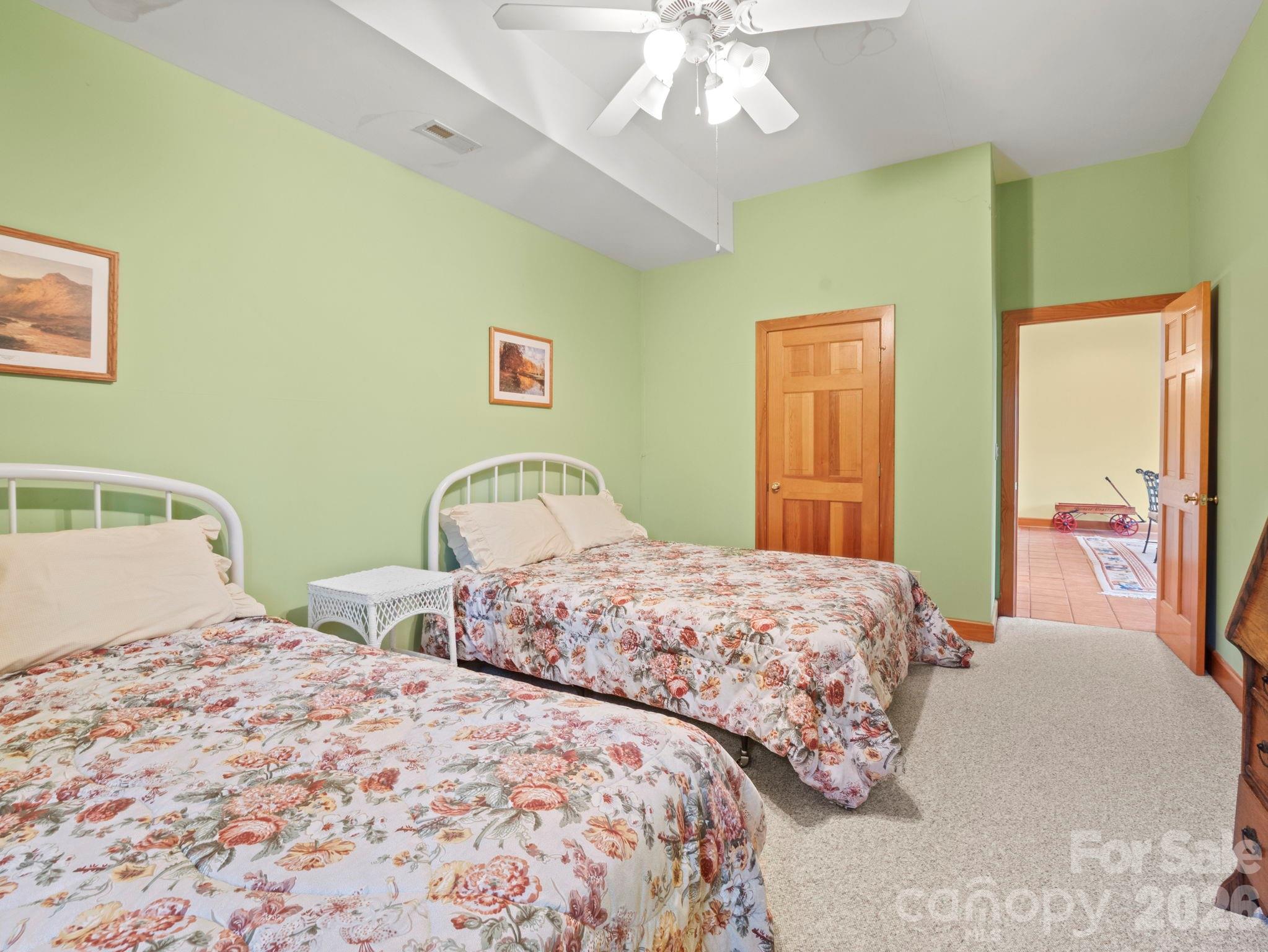 336 Burnt Ridge Road Lake Lure, NC 28746 - Photo 38 of 45 a bedroom with two beds and a chandelier