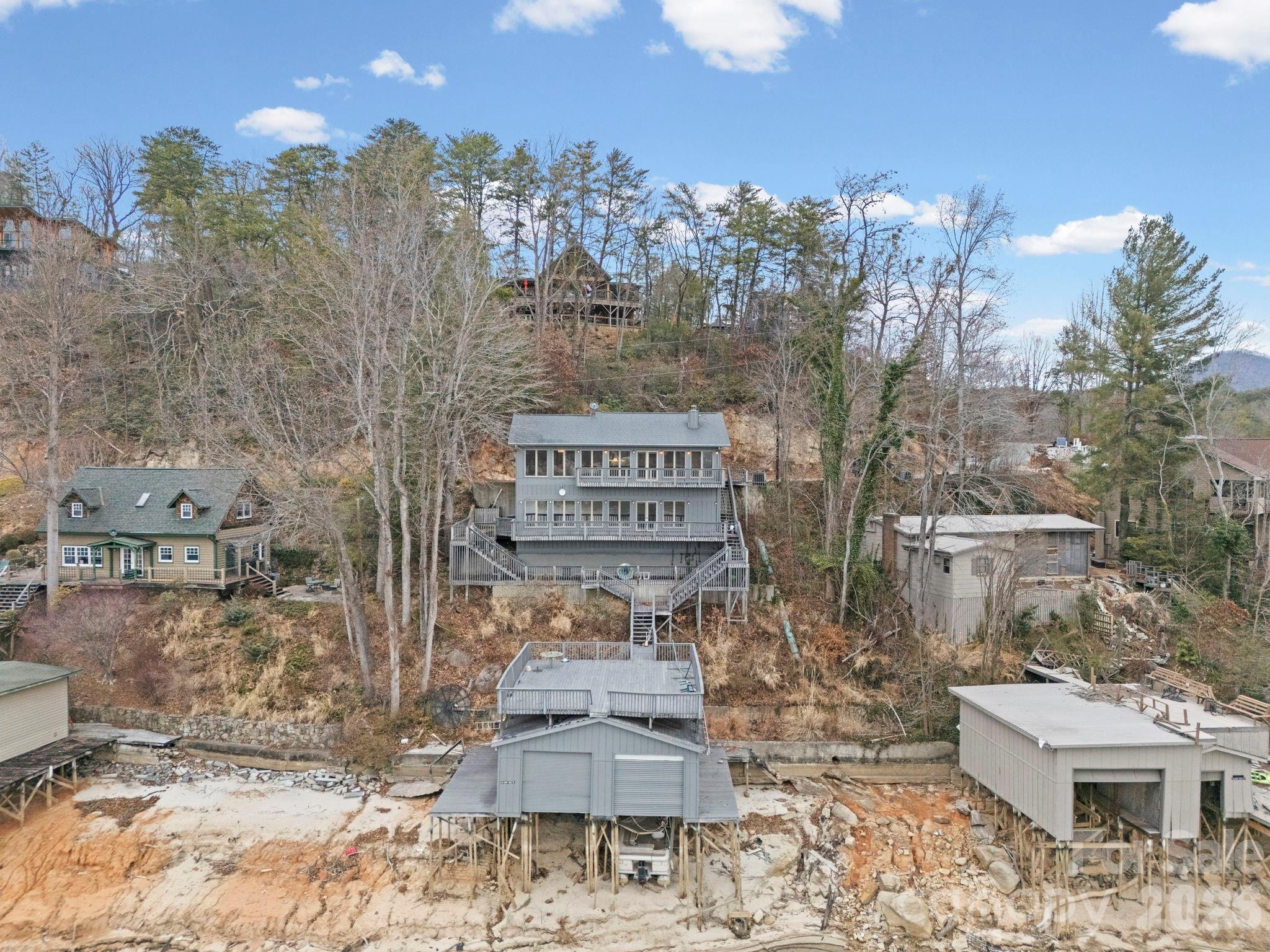336 Burnt Ridge Road Lake Lure, NC 28746 - Photo 42 of 45 a view of a chairs and table in the back yard of the house