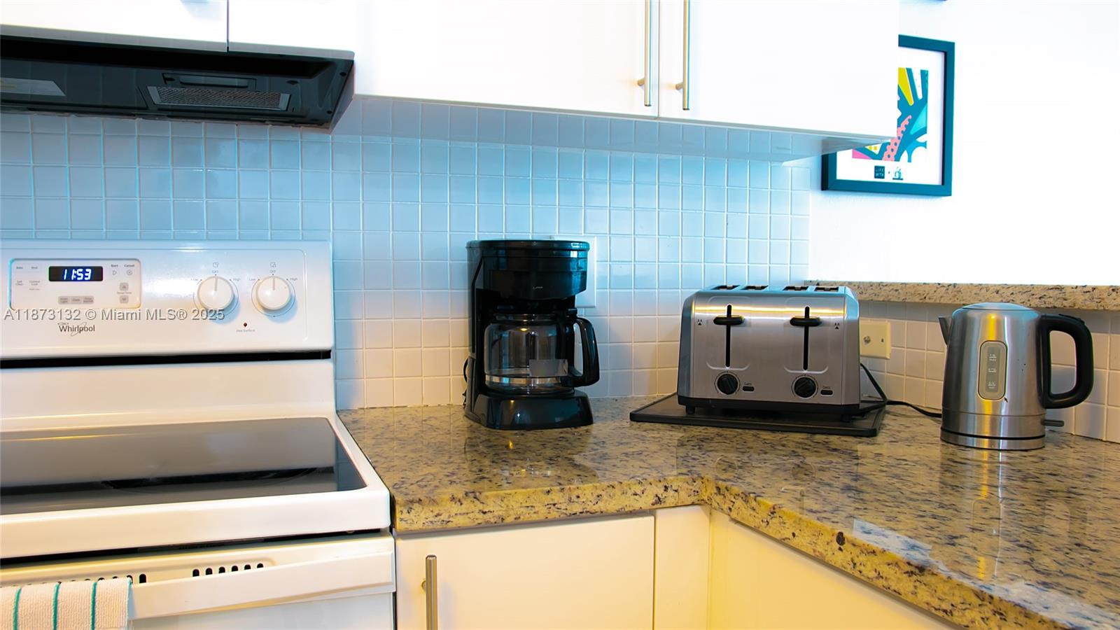 18100 North Bay Road, Unit 905 Sunny Isles Beach, FL 33160 - Photo 15 of 25 a kitchen with a stove and a microwave