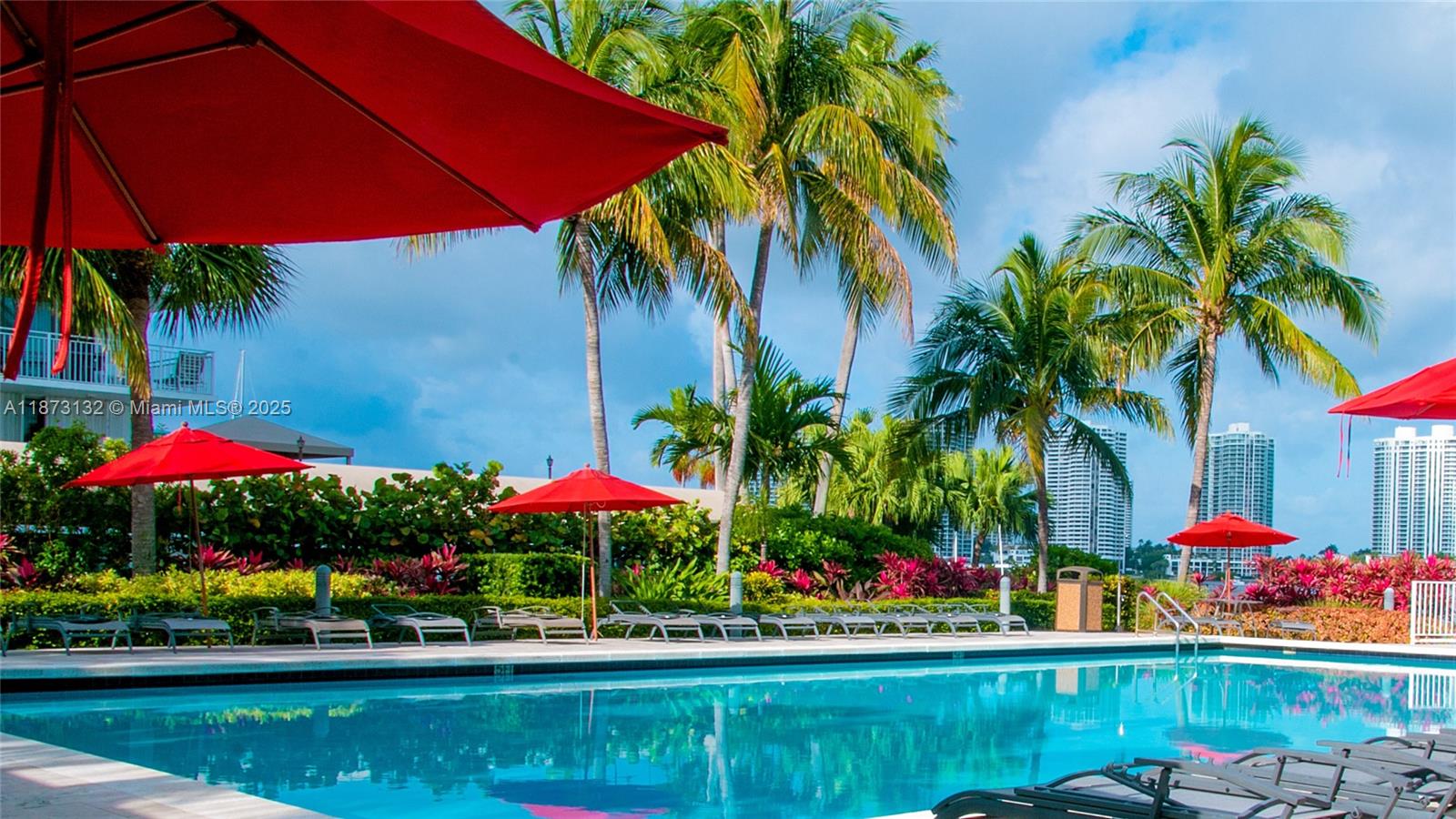 18100 North Bay Road, Unit 905 Sunny Isles Beach, FL 33160 - Photo 2 of 25 a view of swimming pool with a table and chairs under an umbrella
