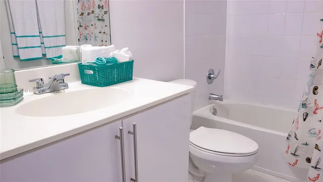a bathroom with a sink a toilet and bathtub
